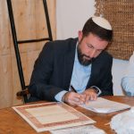 הרב חותם על תעודת כשרות